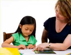 young girl being taught by teacher